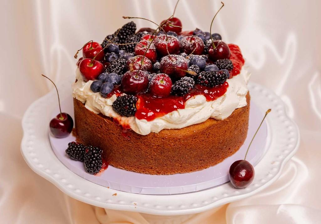 Fresh berry cake on a decorative stand