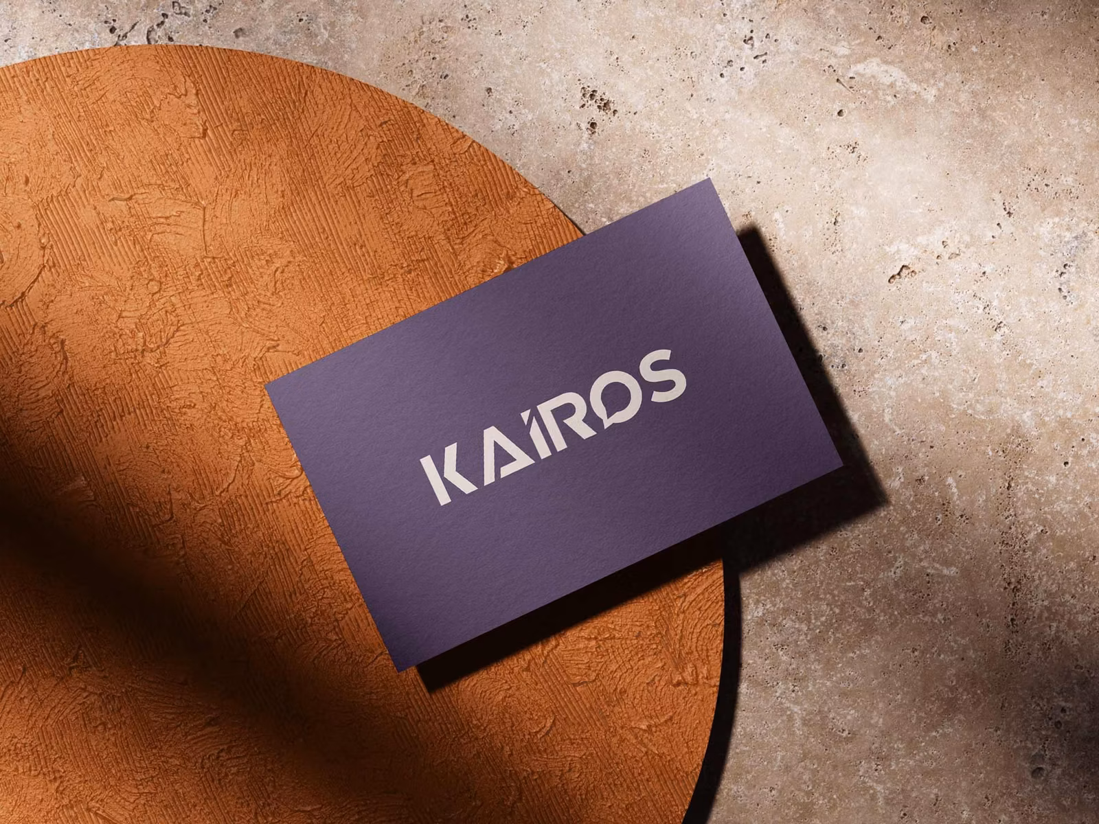 Kairos business card mockup on terracotta and stone surfaces